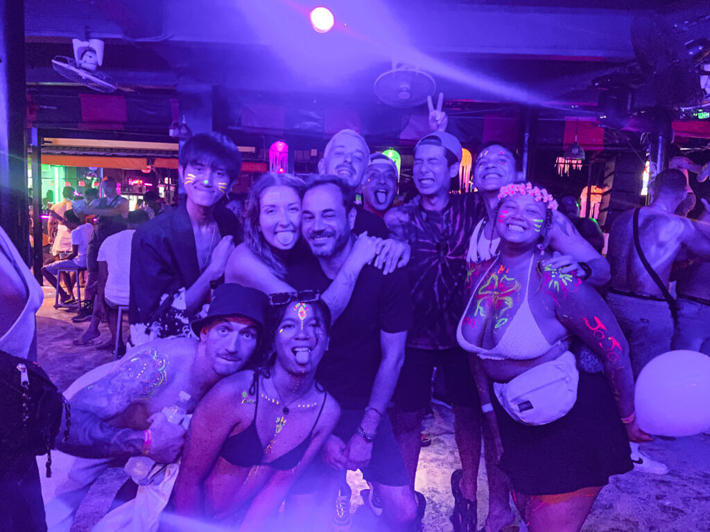 Aly and her friends at the Full Moon Party where everyone is smiling and covered in paint