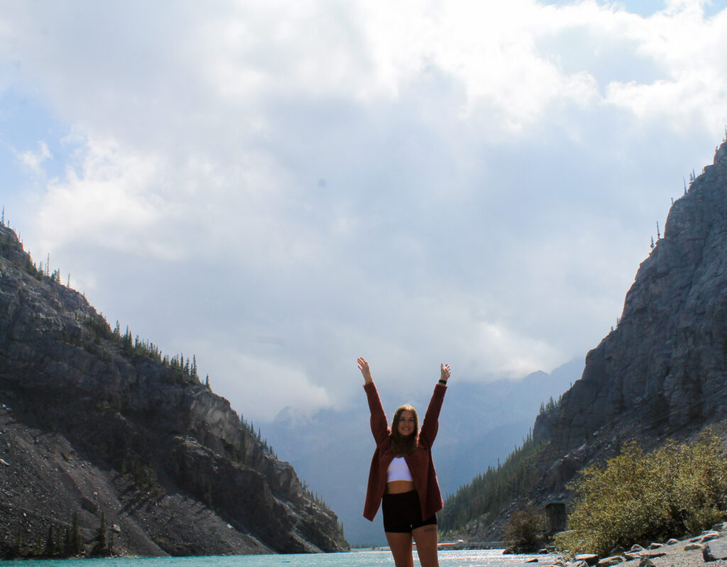 Aly smiling in the mountains.