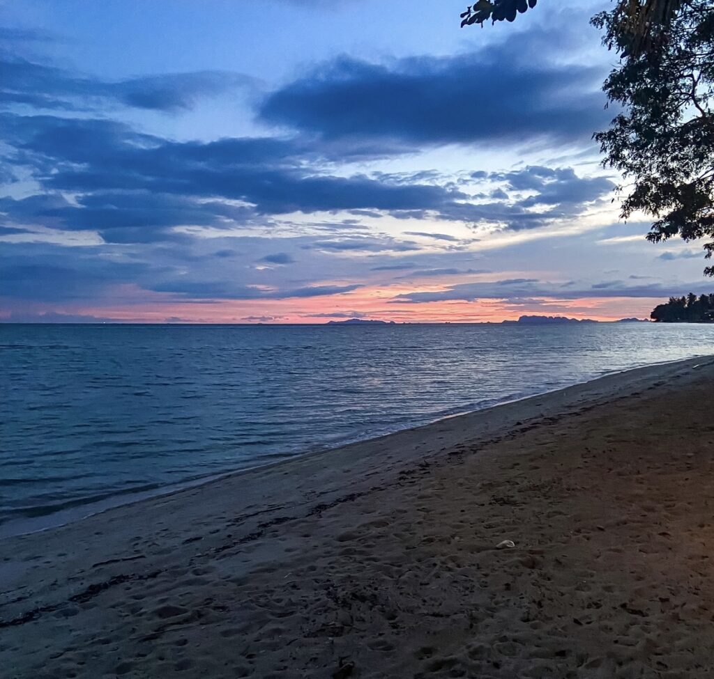 Beach sunset with a blue, orange and pink sky